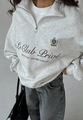 Macro detail of high-quality fabric texture and letter print on gray half-zip sweatshirt - S / Heather Grey