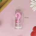 Detailed view of a pink question mark birthday candle in packaging with 2.2x4.1cm dimensions - Boxed-Small / Pink
