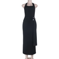 Detail view of the elegant silver metal buckle on the waist of a black halter maxi dress - XS / Black