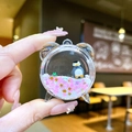 Macro detail of penguin liquid quicksand alarm clock charm with pink heart sequins - White Penguin [Alarm Clock]