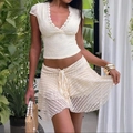 Detailed view of white floral lace texture and deep V-neckline on the slim fit top - XS / Apricot