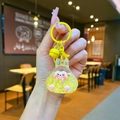 Close-up of cute yellow resin hamster keychain with glitter, small bell, and metal ring - Colorful Hardware Keychain Style / Luminous Bubble Beads Tata (Yellow)