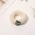 Close-up of fluffy white Christmas scrunchie with a cute green tree ornament - Plush Christmas Tree Hair Tie