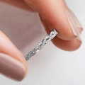 Macro shot of silver infinity twist ring set with small white zircon stones on a hand - Infinity Symbol Style (F1229) White Gold / US 6