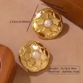 Golden stainless steel round earring with white pearl inlay and geometric starburst relief - Stainless Steel Pearl Geometric Studs