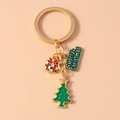 Detail of Christmas keychain with festive gold metal, green tree, and gift box charms - Christmas Tree Letter