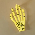Bright yellow skeleton hand hair clip for Halloween parties with black bone texture details - Yellow