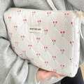 Quilted cotton cherry print makeup bag with polka dots and zip closure held by hand - Red Cherry Handheld Clutch Pouch