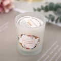 Minimalist scented soy candle in frosted glass jar with eucalyptus and dried flowers decor - English Pear & Freesia