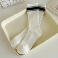 White cotton slouch socks with black stripes on ribbed cuff, displayed in cozy tray - One Size / Cream