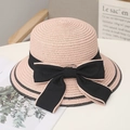 Pink woven straw sun hat for women featuring a large black bow and ribbon trim - One Size / Pink