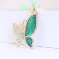 Golden butterfly keychain with clear rhinestones and green enamel on white background - Individual Packaging / Green