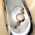 Rose gold adjustable bracelet watch with crystal accents and pull-string closure - Pink