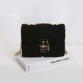 Fashionable black faux fur crossbody bag with gold chain strap and stylish clasp closure - Black