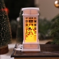 White Christmas telephone booth lantern with snowman scene resting on vintage book - White Snowman