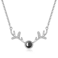 Macro detail of silver reindeer antler necklace with black projection stone and zircon stones - Doe Antler White Gold Color