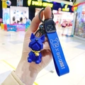 Close-up of a blue geometric French Bulldog keychain with a wrist strap and bell - Single OPP Package / Sapphire Blue