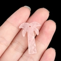Pink natural crystal palm tree pendant held in hand for DIY jewelry making - Rose Quartz