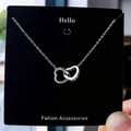 Élégant collier argenté à deux cœurs entrelacés avec une fine chaîne minimaliste - Argenté
