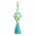 Close-up of mint green silicone flower keychain with a crochet center and matching tassel - Mint Green