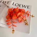 Single stem artificial red orange eucalyptus leaf decoration for autumn home decor - Pumpkin Orange