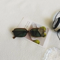 Vintage tortoiseshell rectangular sunglasses with dark lenses on an artistic background - Striped Frame Tea Green Lens