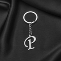 Silver stainless steel keychain with stylized letter P pendant on black silk - Letter P