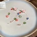 Close-up of colorful beaded flower and butterfly tassel earrings on a ceramic tray - Silver Earring Post Style (158#) / Pink-Green