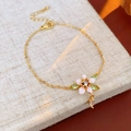 Pink enamel flower bracelet with gold plating and drop charm on linen background - Bracelet-Gold-Pink
