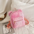 Pink plush backpack with bear ears and smooth metal zipper on soft faux fur surface - Colorful Pink