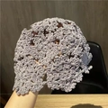 Detailed close-up of grey hand-knitted cotton beanie with hollow floral crochet patterns - M (56-58cm) / Gray