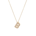 Detailed view of golden letter B pendant necklace with pavé white cubic zirconia stones - Letter B