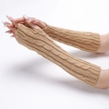 Detail of camel cable knit fingerless gloves showing thick texture and pattern - Camel