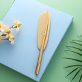 Elegant gold metal feather shape rollerball pen resting on a light blue gift box - 0.5mm / Gold