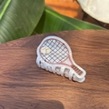 Detail of tennis racket hair claw in white marble acetate on a rustic wooden surface - Pink Tennis Racket - Hair Claw