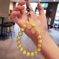 Yellow macaron bead phone strap with cream floral charm and transparent acrylic beads - Yellow Flower Yellow Beads
