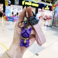 Detailed macro view of a purple geometric French Bulldog keychain featuring a pink leather strap - Single OPP Package / Dark Purple