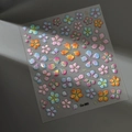 Macro view of 3D embossed floral nail stickers with iridescent finish and shell luster - Iridescent Gradient Flower Style (CO-360)