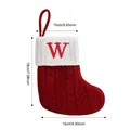 Red knit Christmas stocking with cat paw design and embroidered letters, 18cm height - Letter W