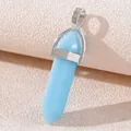 Light blue hexagonal crystal prism pendant with silver clasp on textured surface - Luminous Blue