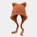 Detail of chunky knit winter hat featuring cat ears and warm caramel orange yarn texture - Caramel color