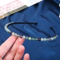 Handmade headband featuring multi-color natural crystal beads on a slim black metal frame - 6mm Fluorite