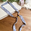Macro detail of the plaid chiffon necklace featuring unique wood and acrylic bead accents - Necklace-Blue
