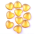 Polished heart-shaped amber yellow crystals arranged on white background - Smelted Yellow Crystal