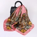 Close-up of pink paisley silk scarf draped on a black leather handbag for styling - D9239-Pink