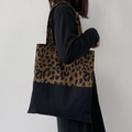 Detail of leopard print canvas tote bag featuring reinforced black base and large capacity - Leopard Print Patchwork Black Canvas Bag