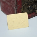 Close-up of small beige kraft paper earring display card with dual pre-punched holes - 500 Sheets / Yellow Leather Texture
