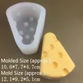 Cheese-shaped silicone mold with finished wax model showing precise product dimensions - Large Rounded Cheese Mold - Translucent