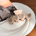 Beige hair claw clip featuring four silver heart accents for a minimalist aesthetic - Brown