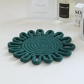 Macro detail of dark green woven cotton coaster with decorative scalloped edges and spiral design - 18cm / Dark Green